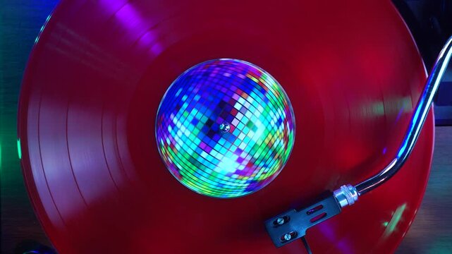 Playback or Red Vinyl Record With Disco Ball Sticker and Party Club Lights, Top Down View