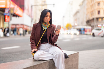 Woman using smartphone connecting with urban digital world © OscarStock