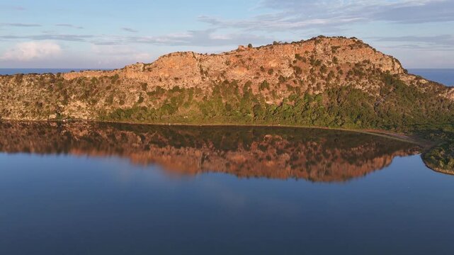 Navarin,Messinia,Aerial view backwards from the island towards the bay, beautiful reflection of the hill on calm water.