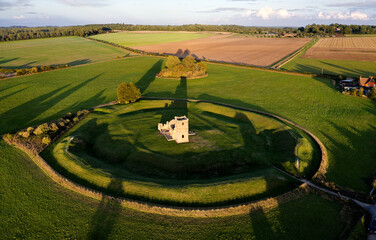 Church Henge. Part of Knowlton Rings Neolithic and Bronze Age earthworks, Dorset. 12th C Knowlton Church central. Great Barrow at 12 o&rsquo;clock. View to E