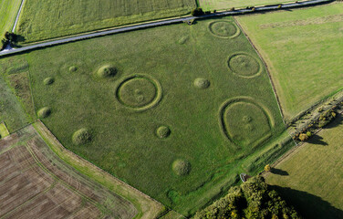 Oakley Down Barrow Cemetery, Dorset. Bronze Age mounds, disc and bowl barrow inhumation and cremation burials. Ackling Dyke Roman Road bottom right