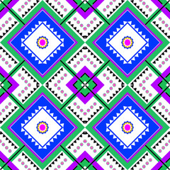 Colorful tribal geometric textile pattern, repeating diamond shapes, bold blue center panels with white inner diamonds, triangular border motifs, green and purple accent blocks, small circular flower.
