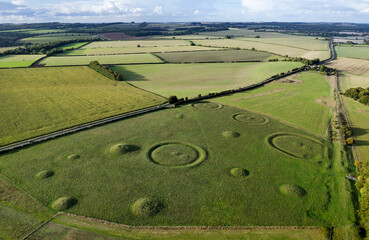 Oakley Down Barrow Cemetery, Dorset. Bronze Age mounds, disc and bowl barrow inhumation and cremation burials.  Ackling Dyke Roman Road at right side