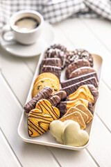 Christmas sweet and cookies on plate on white table.