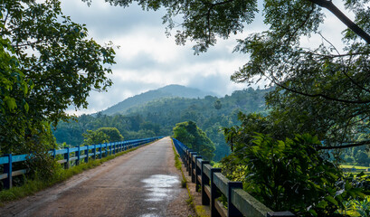 Scenic bridge in Kizhur, Ottapalam, Kerala, India, surrounded by lush greenery and misty hills, a popular filming location for South Indian movies, showcasing serene rural landscape and cinematic coun