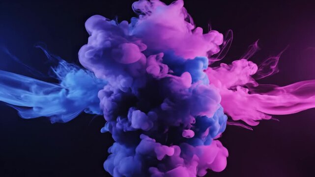Ink Cloud Explosion - A dramatic shot captures a cloud of colored ink dispersing in water. The ink cloud is comprised of vibrant hues of pink and blue, contrasting against a dark backdrop.