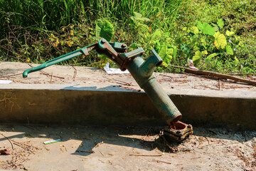 Old broken water pump on the concrete road in the countryside of Bangladesh.
