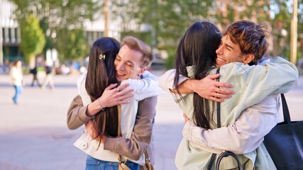 Young diverse friends embracing outdoors feeling happiness and inclusion