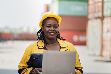 Portrait African woman logistics workers use notebook computer checking container	