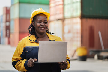 Portrait African woman logistics workers use notebook computer checking container	