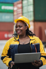 Portrait African woman logistics workers use notebook computer checking container	