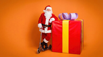 Modern Santa Claus with Scooter and Giant Gift Box on Orange Background