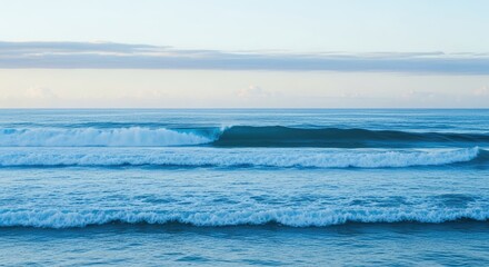A view of ocean waves rolling towards the shore under a cloudy sky day