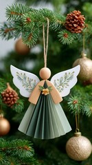 Obraz premium Handmade angel ornament hanging on Christmas tree branch