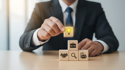 Business Innovation: Stacking Blocks with Lightbulb and Iconic Elements

