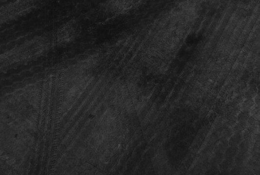 Close up black tire marks on cement floor.