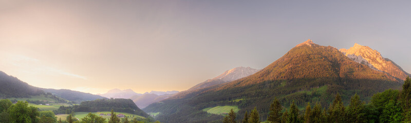 Fototapeta premium Meadow with road and bench during sunset in Berchtesgaden National Park