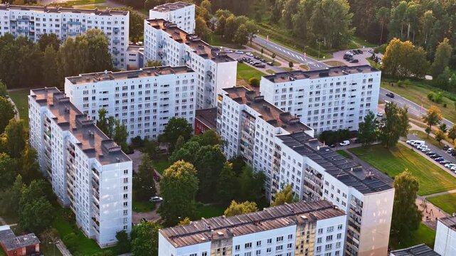 Soviet-era apartment buildings with green courtyard in Jelgava, Latvia in aerial view at golden hour