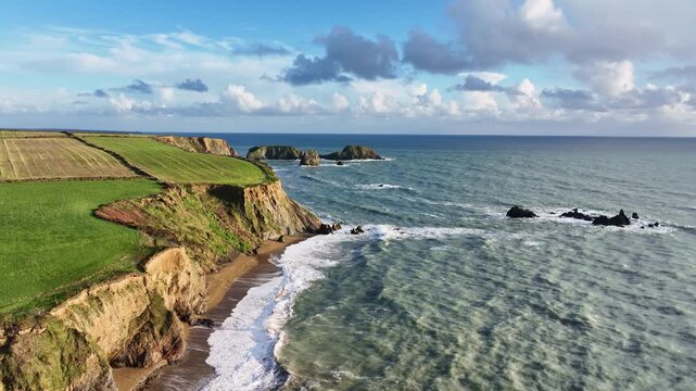 Ireland epic Coastline Atlantic winter storm waves on beach fragile sea cliffs prone to erosion Copper Coast Waterford