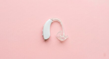 Single Hearing Aid on Pastel Pink Background in Minimal Flat-Lay Style
