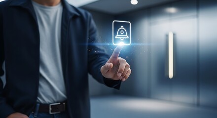 Man touching a glowing bell icon, symbolizing notifications and digital communication in a modern setting.