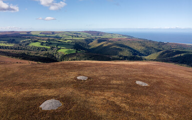 Dunkerry Hill, Exmoor, Somerset. Bronze Age burial mound cairns near Dunkerry Beacon. Joaney How (R) and Robin How (mid). View NW to Bristol Channel