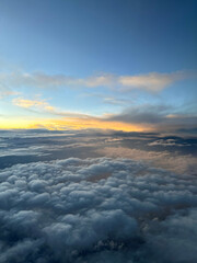 Dramatic cloudscape during sunrise from the airplane's window