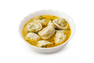 Dumplings served in flavorful broth with fresh herbs in a white bowl