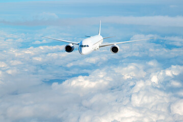 White passenger airplane flying in the sky amazing clouds in the background - Travel by air transport