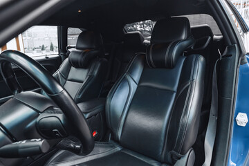 Luxury car interior features sleek black leather seats and modern design elements