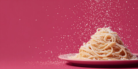 Delicate plate of spaghetti with cheese on magenta backdrop, evoking joy