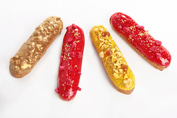 Glazed eclairs on a white background. A set of eclairs on a white background. French classic dessert. An isolated object.