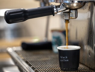 Coffee making process in work environment, Coffee mashine making fresh cup of espresso. Black...