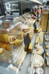 Display of assorted pastries and desserts in a modern cafe setting