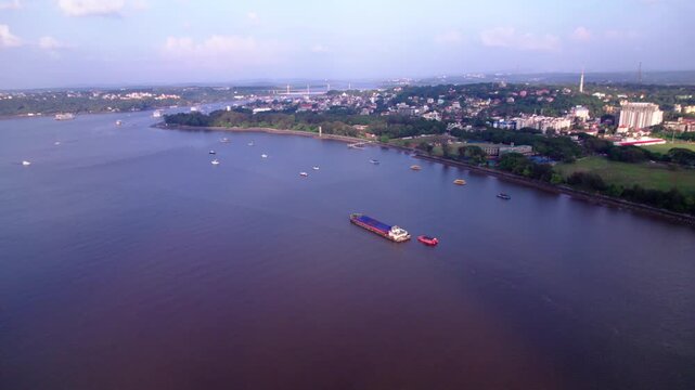 Aerial view of Panaji city with Mandovi River, ships and Atal Setu bridge at goa. day time, Dolly Up shot, drone shot, 4k.