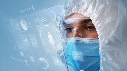 Medical professional analyzing data in protective gear during a research session