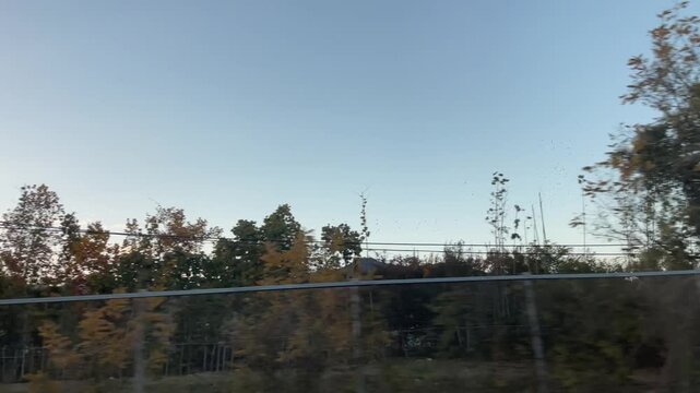 Sunset sky scenery filmed from a moving car in Korea &ndash; warm evening clouds and peaceful roadside landscape

