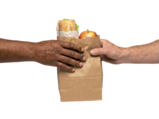 Person Handing Brown Paper Bag With Sandwich And Apple To Another Person