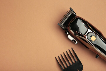 Hair clipper on brown background. Modern hair clipper.