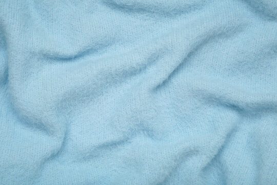 Knitwear, blue angora. Natural woolen fabric, fragment of a sweater.