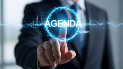 Businessman touching the word agenda on a digital interface with futuristic glowing elements and data graphs