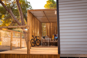 Road bicycle parked on a wooden terrace on a pine tree landscape in Girona, Catalonia