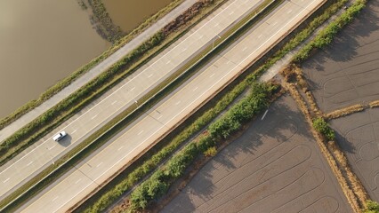 Aerial view of street in Bangkok Thailand with cars and countryside