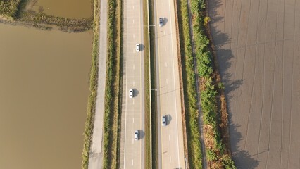 Aerial view of street in Bangkok Thailand with cars and countryside