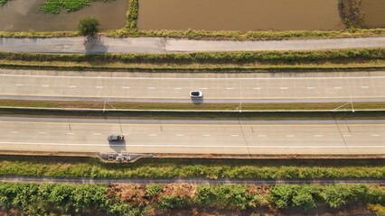 Aerial view of street in Bangkok Thailand with cars and countryside