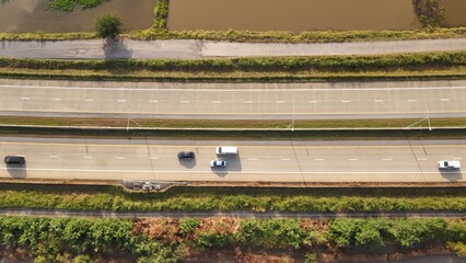 Aerial view of street in Bangkok Thailand with cars and countryside