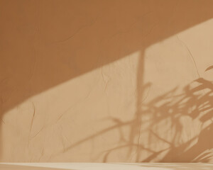 Textured beige wall with diagonal sunlight and shadow of palm leaves plaster stucco