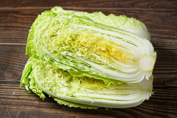 fresh chinese cabbage and a cut one on wood table.