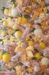 Christmas tree with lemons, flowers, and yellow decorations