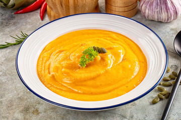 Tasty pumpkin cream soup served seeds